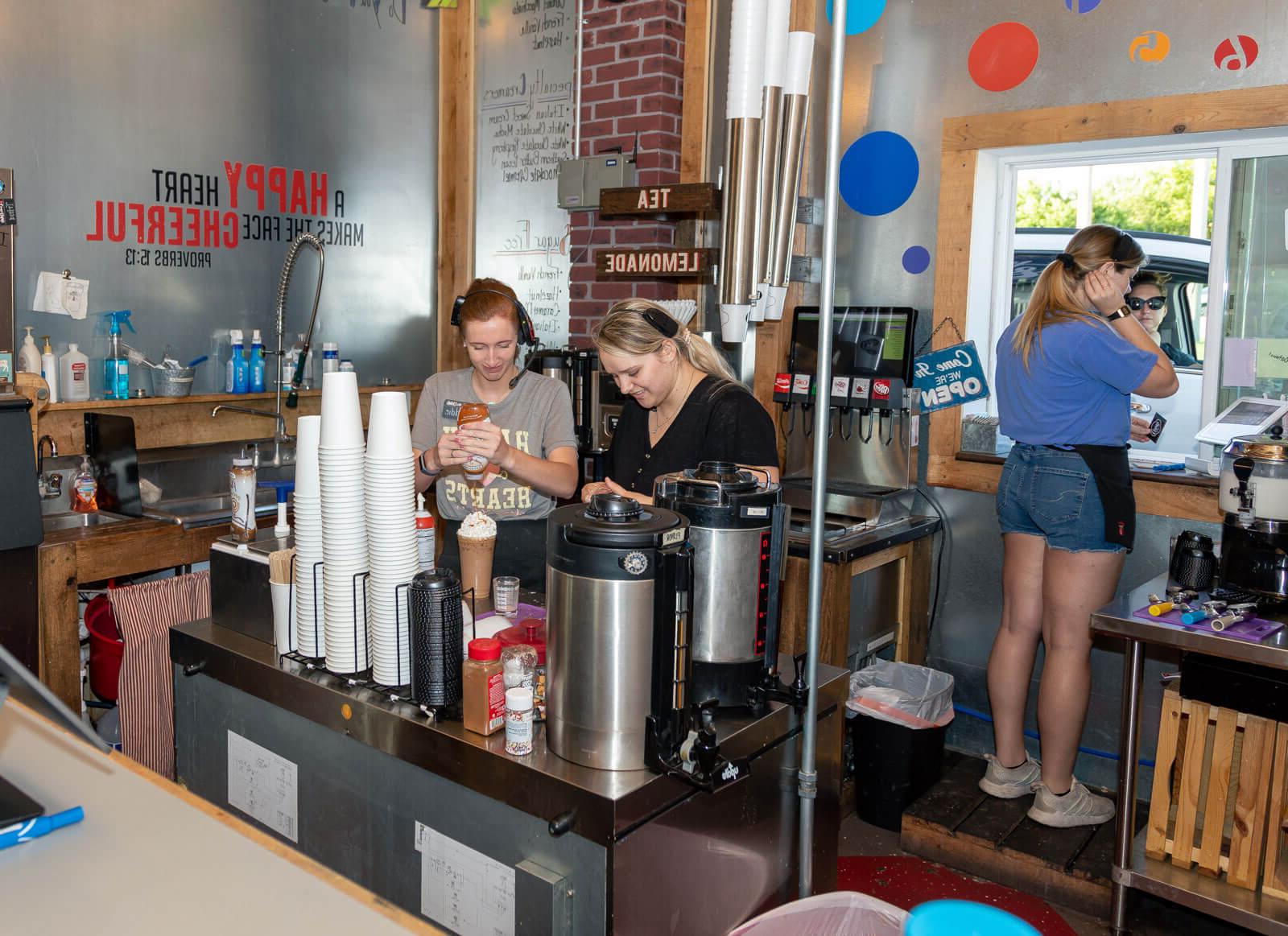 female baristas prepare drinks at Creator Delights